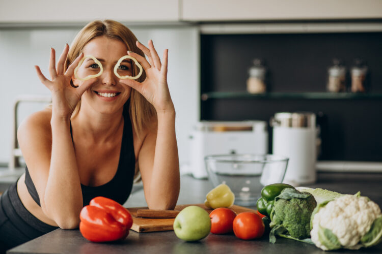 Sporty woman kitchen fresh peppers