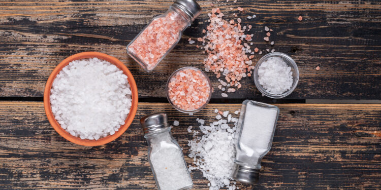 Sea salt and Himalayan salt in bowls and shakers, illustrating 'Celtic Salt vs Himalayan Salt' comparison