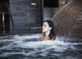 10 benefits of cold showers - Woman experiencing the benefits of cold water therapy in a natural pool