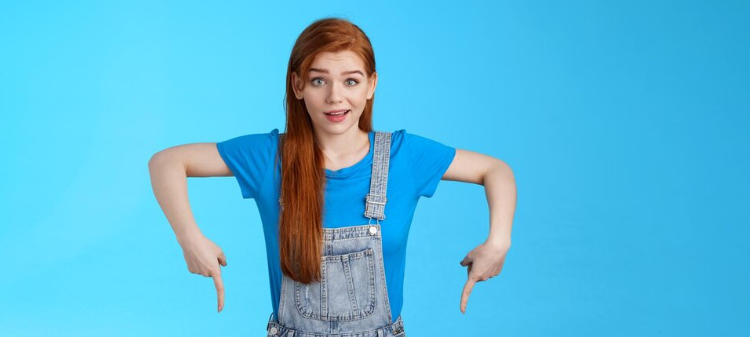 Girl pointing to a comprehensive list of Key FAQs Answered about Red Light Therapy at Home